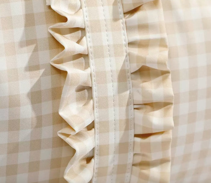 close up detail of ruffles on gingham duffle bag