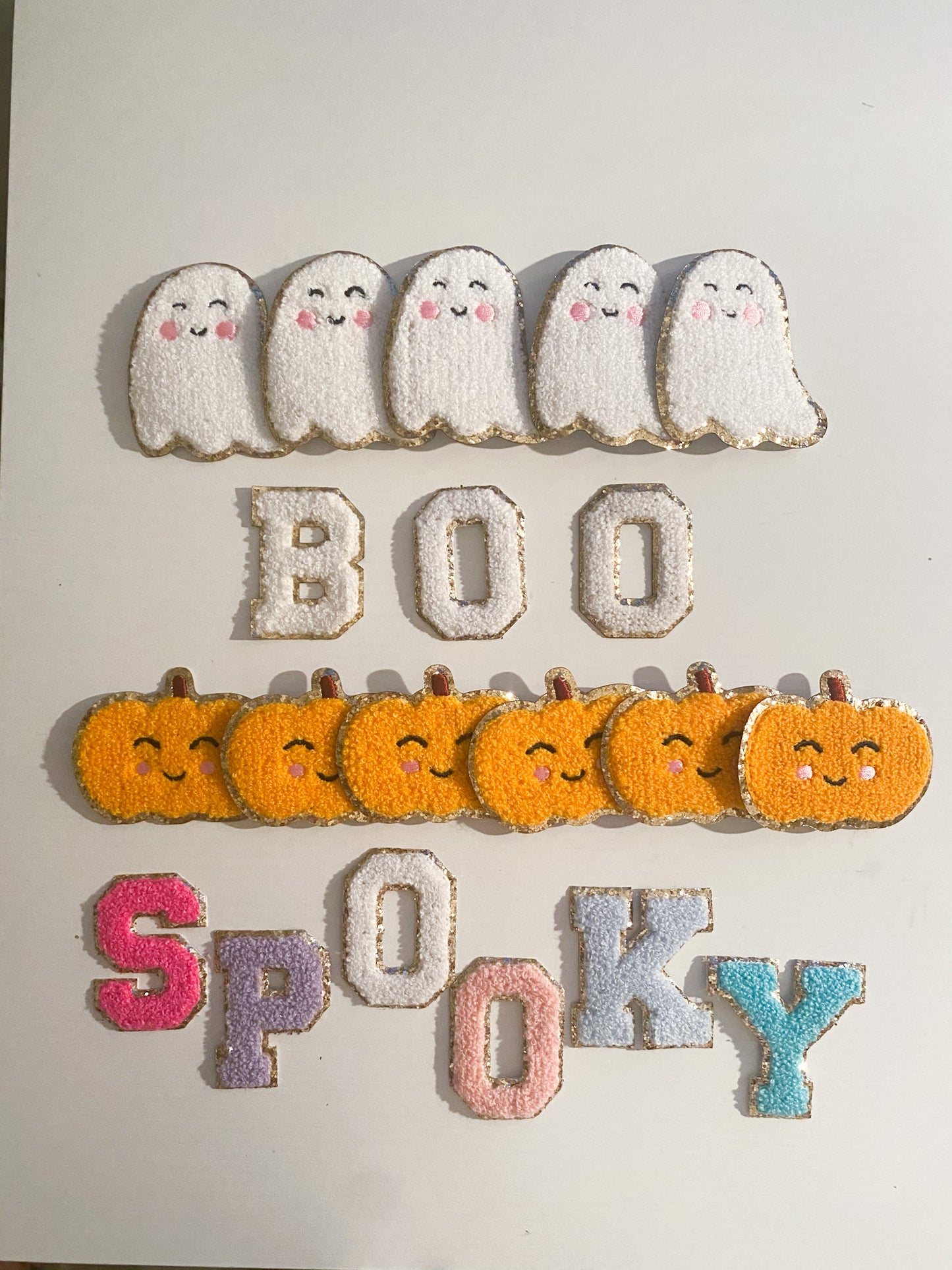 halloween chenille patches. white ghost, orange pumpkin, and letters spelling "boo" and "spooky"