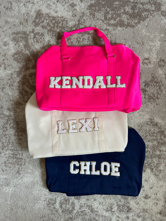 personalized duffle bag with patches. hot pink duffle bag, beige duffle bag, navy blue duffle bag with white chenille patches. custom nylon duffle bags