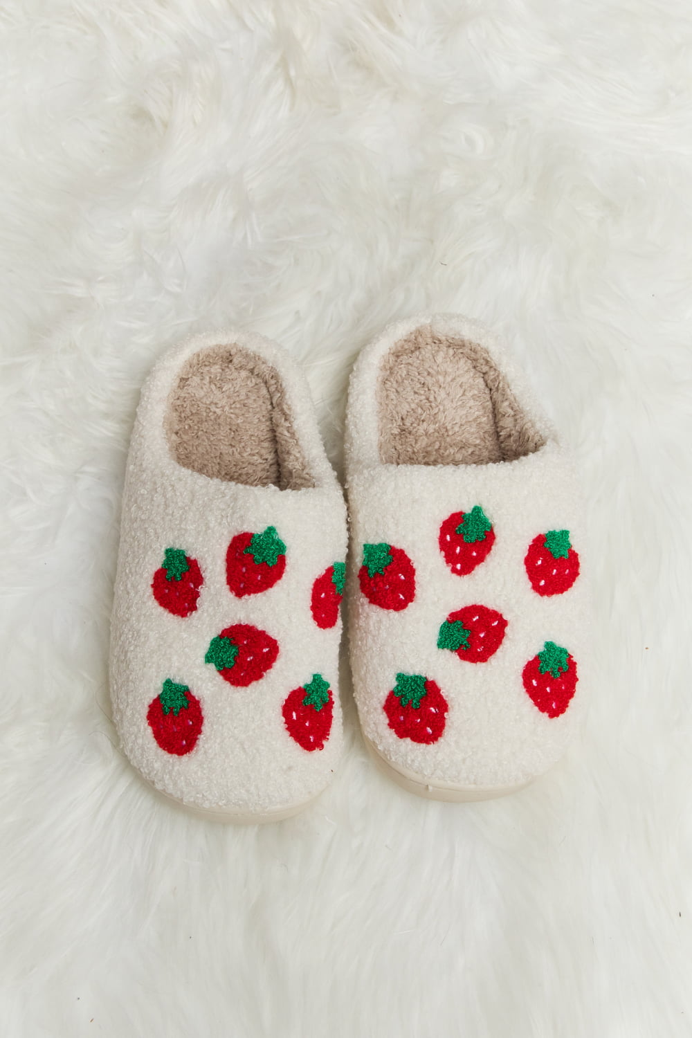 white slippers with a strawberry print