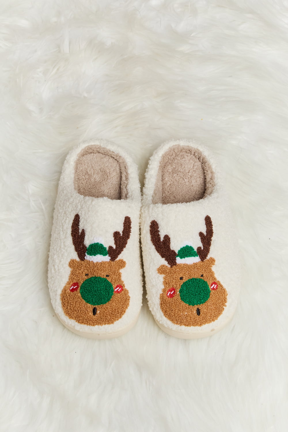 christmas slippers with a reindeer face with green nose